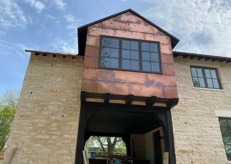 Copper metal panel facade on a stone building for Roof Repair in Thomasville
