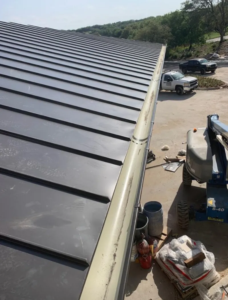 Standing seam panel and gutter detail on a metal roofing jobsite in Thomasville